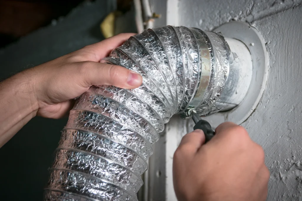 repair tech working on a duct