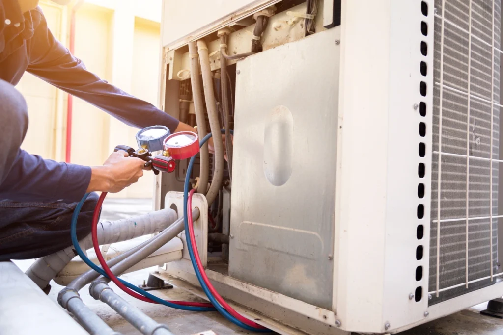 Repair technician working on air conditioner