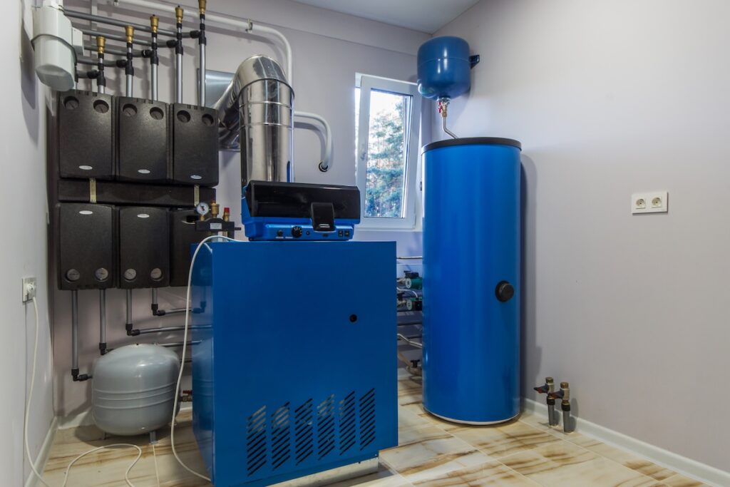 Gas Boiler room in a private house.  Heating system with hot water thermal storage tank