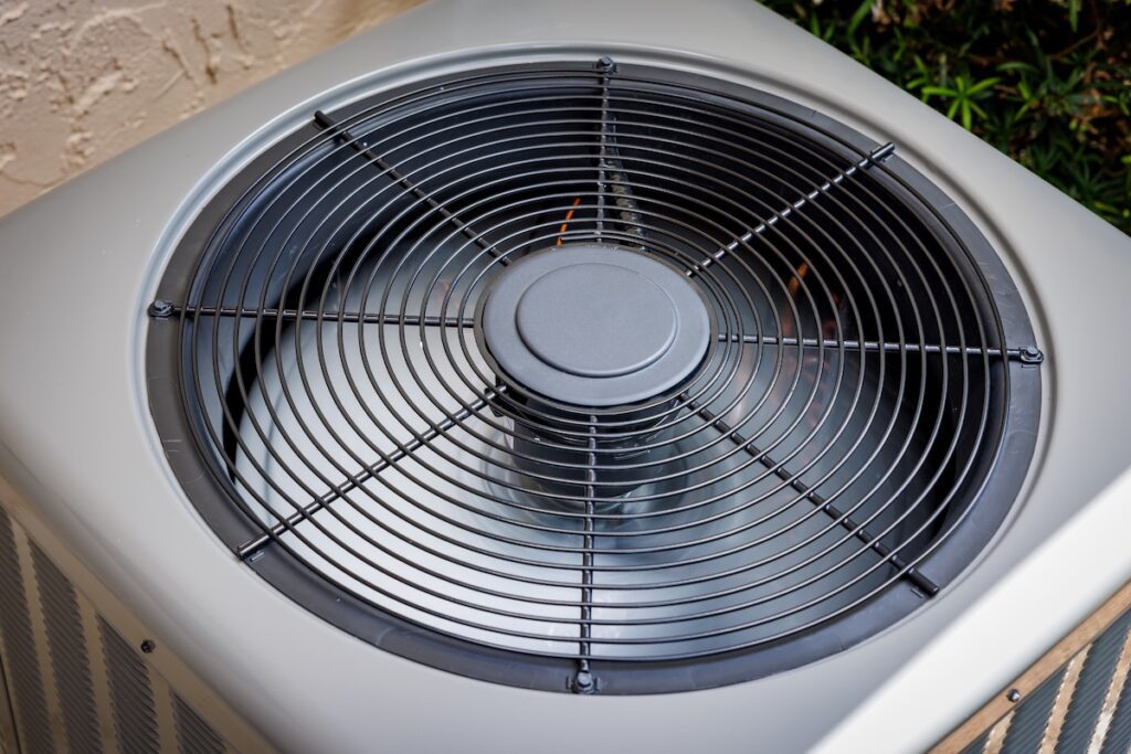 Modern residential HVAC air conditioner unit fan top view.