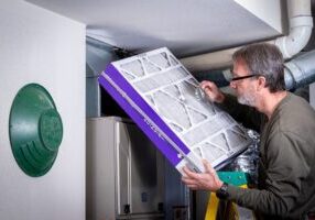 Resident inspects his filter for cleanliness