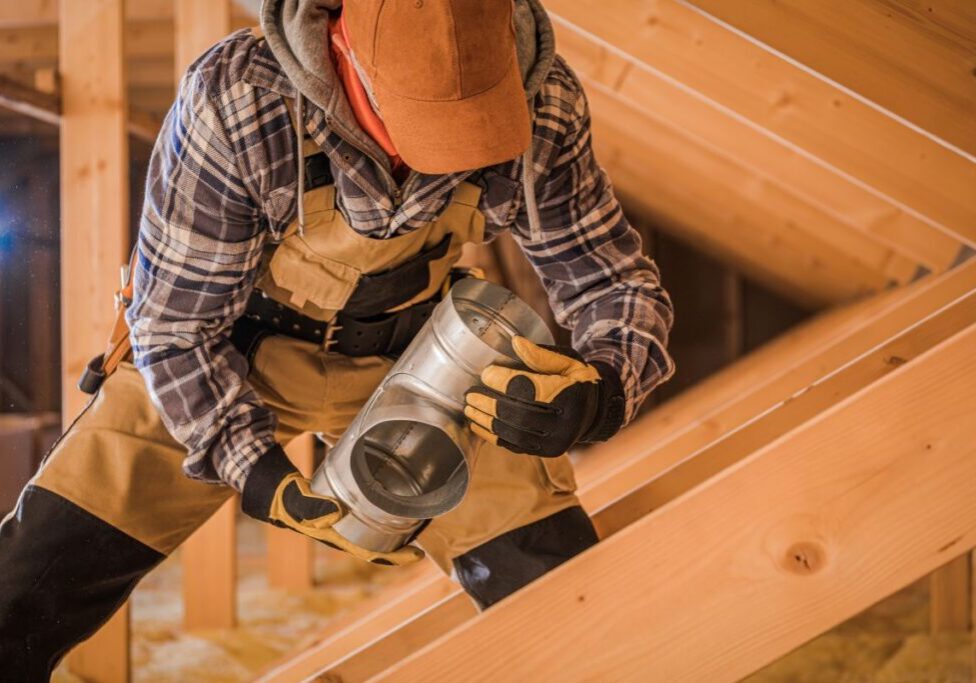 how to install heating and air conditioning ducts man holding air conditioning tubes installing inside home