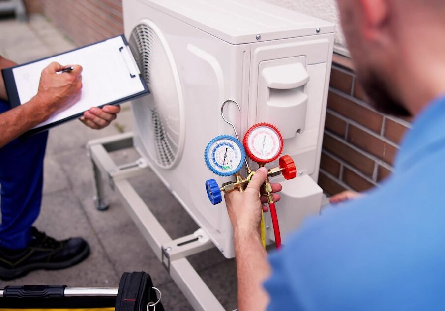 worker testing air conditioning unit