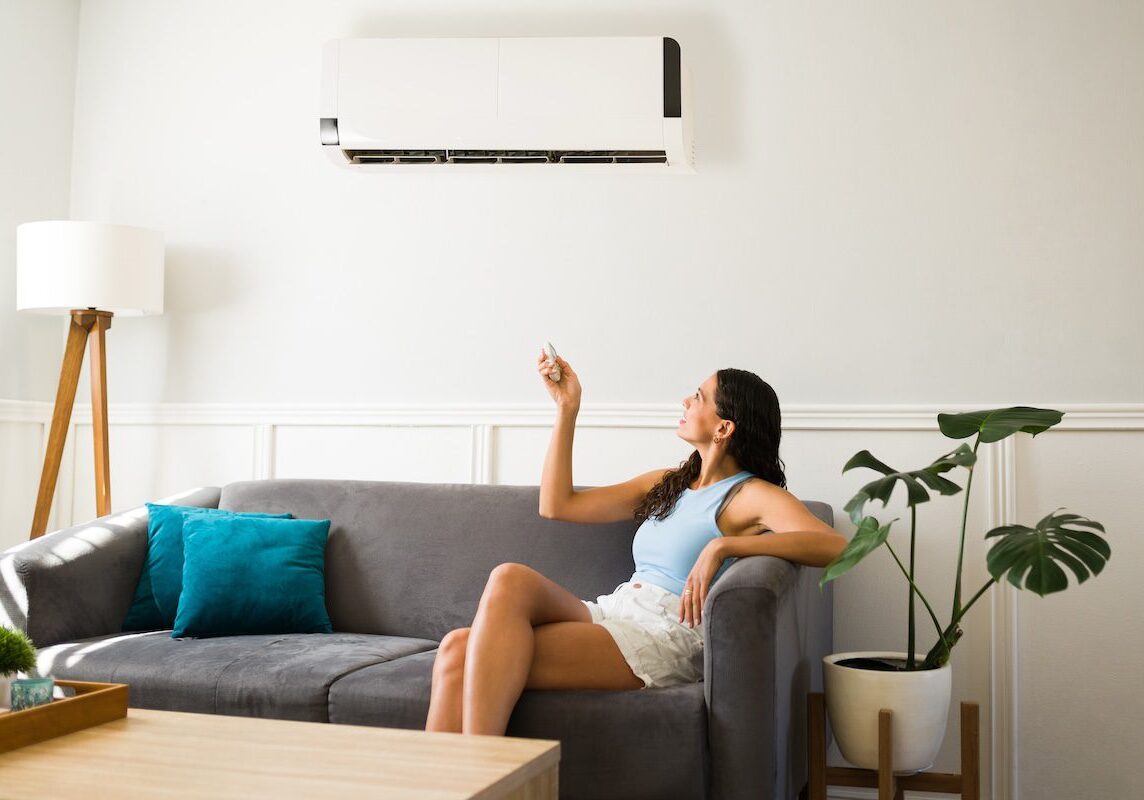 woman using her ac unit in hot weather